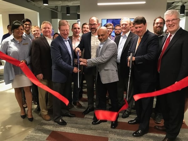 City of Sandy Springs representatives and officers of the Sandy Springs Perimeter Chamber join Axis President and Mayor Rusty Paul in the Ribbon Cutting ceremony at  the recent Axis Group opening.